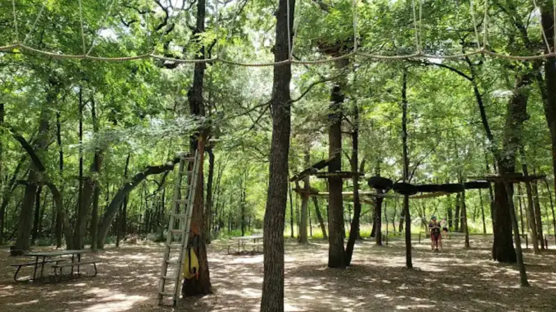 Aerial rope challenge course and zipline platforms suspended in the Great Trinity Forest in Dallas